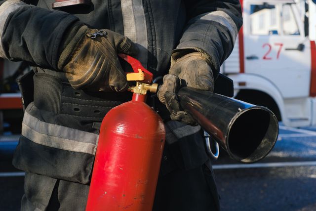Firefighter holding fire extinguisher